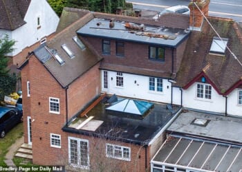 Pictured: The rear of Khalid Hussain's property. A large dormer was built in the loft without planning permission, and a thin to the column to the left holding three bathrooms were built without approval
