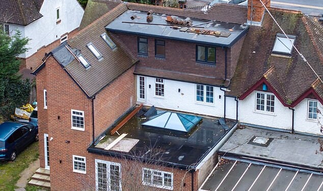 Pictured: The rear of Khalid Hussain's property. A large dormer was built in the loft without planning permission, and a thin to the column to the left holding three bathrooms were built without approval