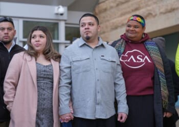 Kilmar Abrego Garcia, center, holds hands with his wife Jennifer Vasquez Sura while leaving the United States District Court District of Maryland, Monday in Greenbelt, Maryland.