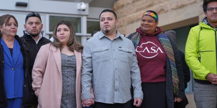 Kilmar Abrego Garcia, center, holds hands with his wife Jennifer Vasquez Sura while leaving the United States District Court District of Maryland, Monday in Greenbelt, Maryland.