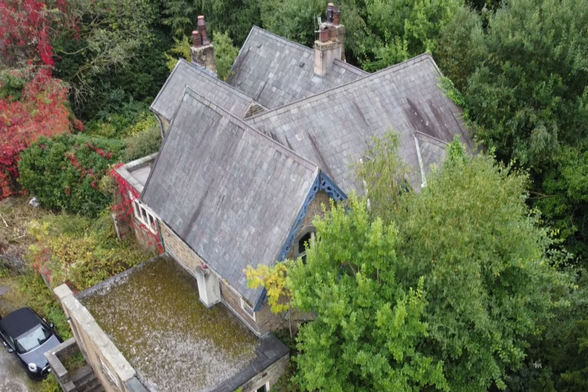 An image collage containing 1 images, Image 1 shows Aerial view of Brooklands House in Burnley, showing its roof and surrounding greenery