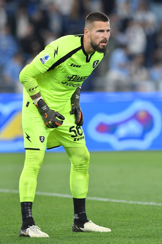 Salernitana player Benoit Costil in a neon green uniform during a match.