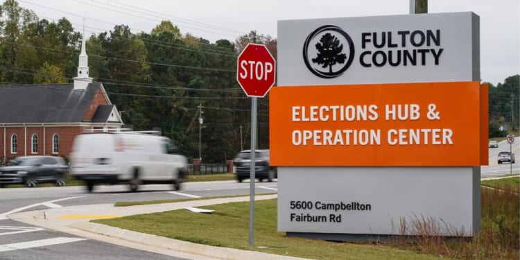 Vehicles pass by the sign for the Fulton County Elections Hub and Operations Center on Nov. 4, 2024, in Union City, Georgia.