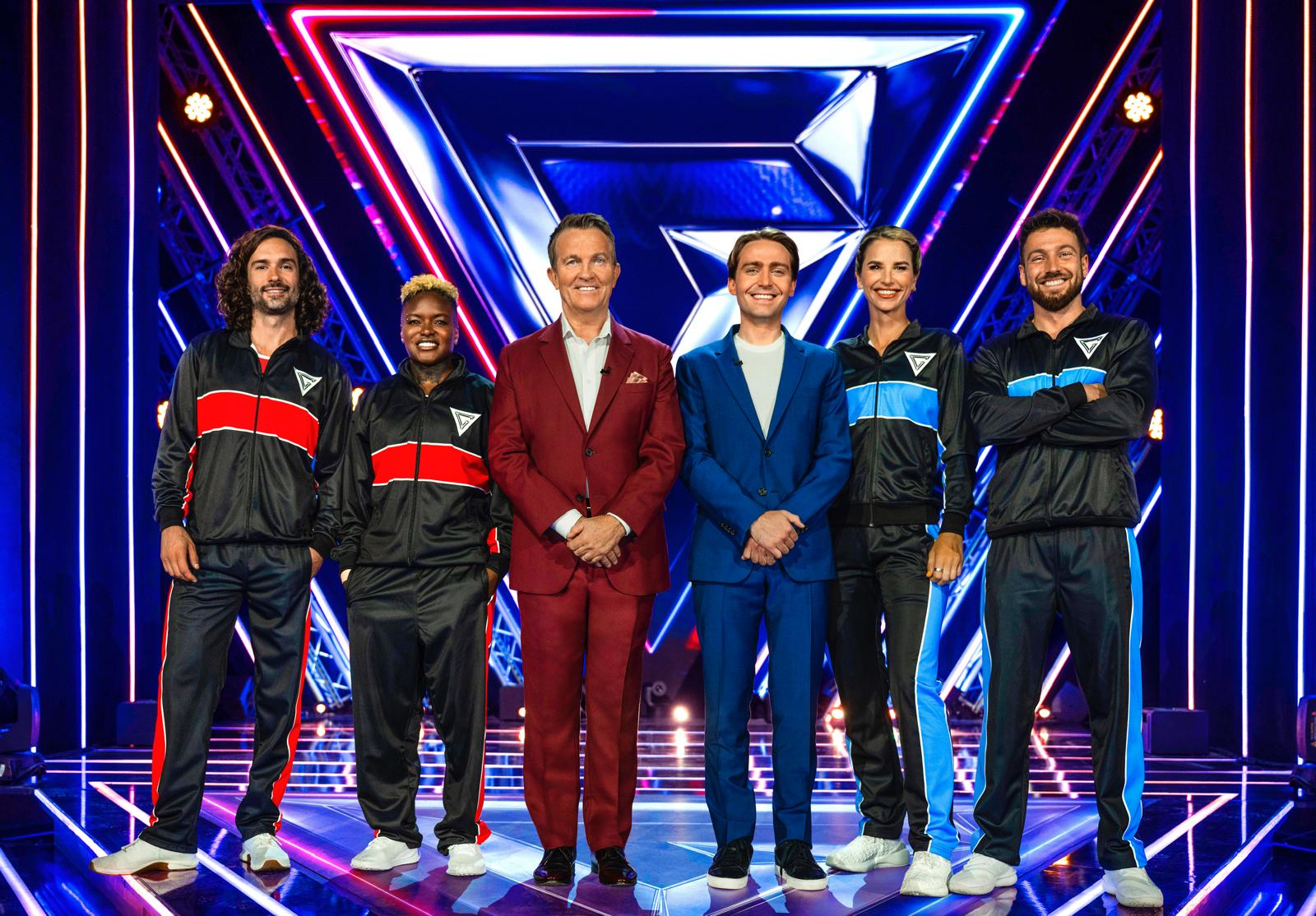 Joe Wicks, Nicola Adams, Bradley Walsh, Roman Kemp, Vogue Williams, and Sam Thompson posing on the set of Celebrity Gladiators.