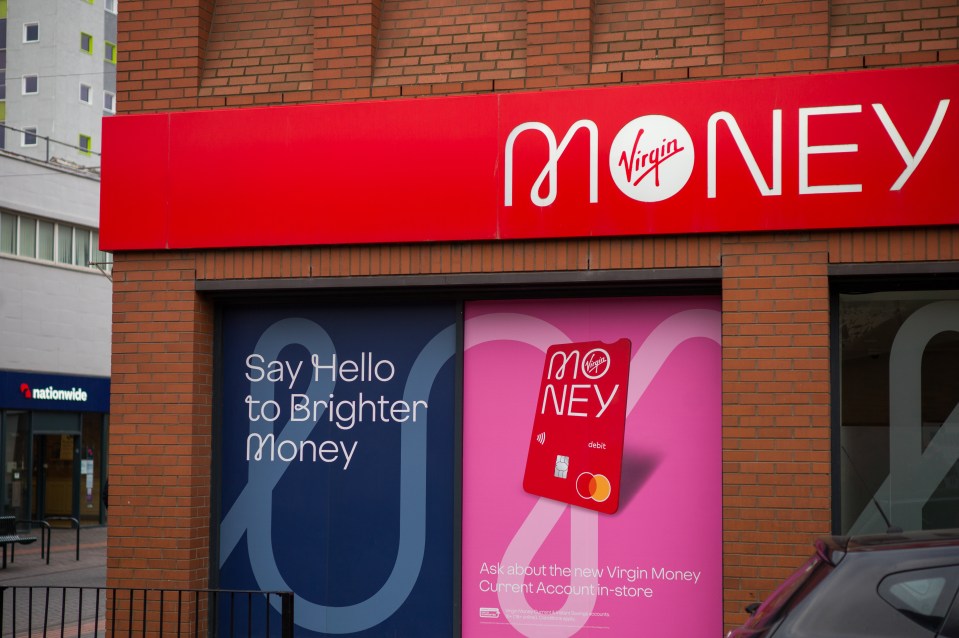 A Virgin Money branch with a red sign, storefront windows advertising "Say Hello to Brighter Money" and a new debit card, and a Nationwide branch visible in the background.