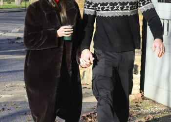 Holly Ramsay and Adam Peaty held hands as they joined her family on a Christmas morning walk - as his estranged mother and father stepped out alone two days before their big A-list wedding