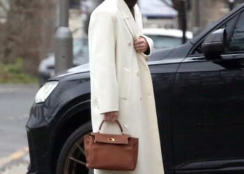 Holly Ramsay, 25, stunned in a white coat as she headed to Bath with her family ahead of her wedding to Adam Peaty amid his family feud