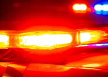 Police lights shine on top of first responder vehicles.