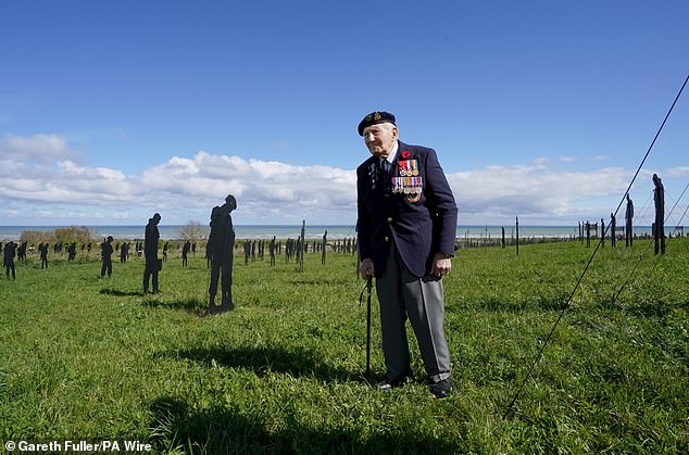Mr Kersh is pictured in November last year standing amongst the Standing with Giants silhouettes at the For Your Tomorrow installation at the British Normandy Memorial, in Ver-Sur-Mer, France