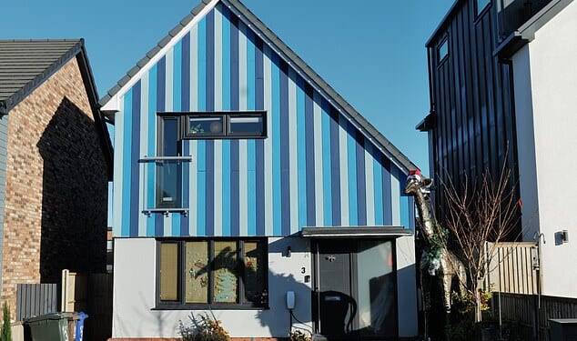Pictured: This stripey blue home had a life-sized giraffe standing guard by the front door
