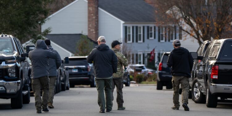 FBI agents gather in front of the home of the suspected Jan. 6, 2021, pipe bomber on Dec. 4, 2025, in Woodbridge, Virginia.