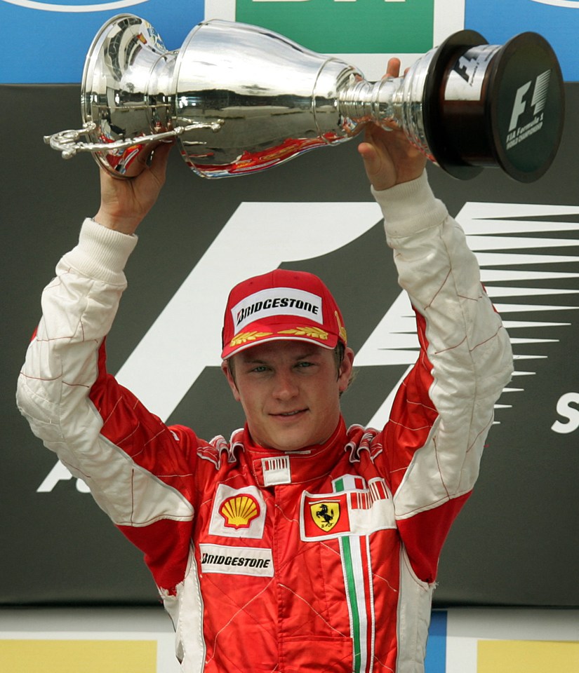 Kimi Raikkonen holding his F1 World Championship trophy.