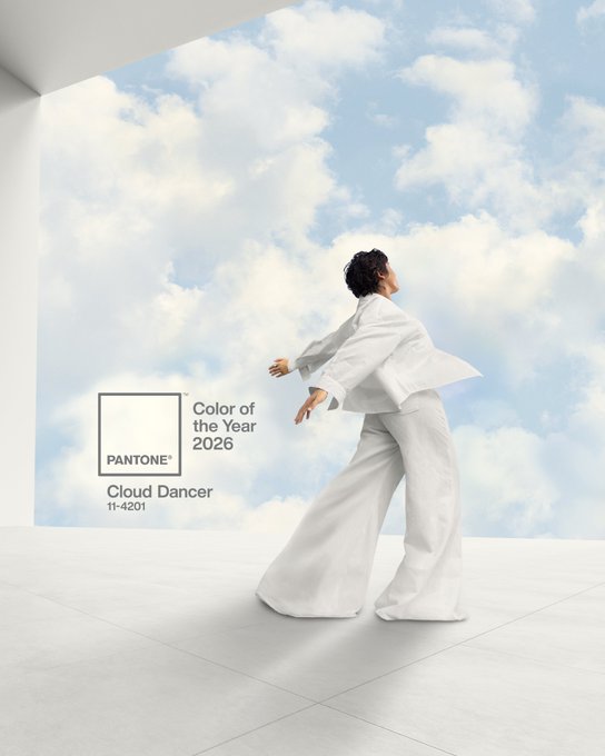 Pantone Color of the Year 2026 is Cloud Dancer, a soft white, shown with a person in white clothing dancing against a cloudy sky.