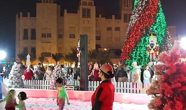 Under a sea of twinkling lights, children frolic in snow and penguins waddle around a marching band of Candy Cane men playing festive tunes