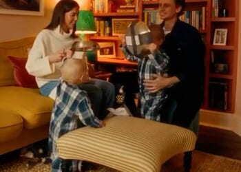 The mother (pictured) gleefully opens the presents while declaring 'You know we needed frying pans,' as she thanks the children for the gifts