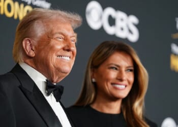 President Donald Trump grins as he attends the 48th annual Kennedy Center Honors on Dec. 7 in Washington with first lady Melania Trump.