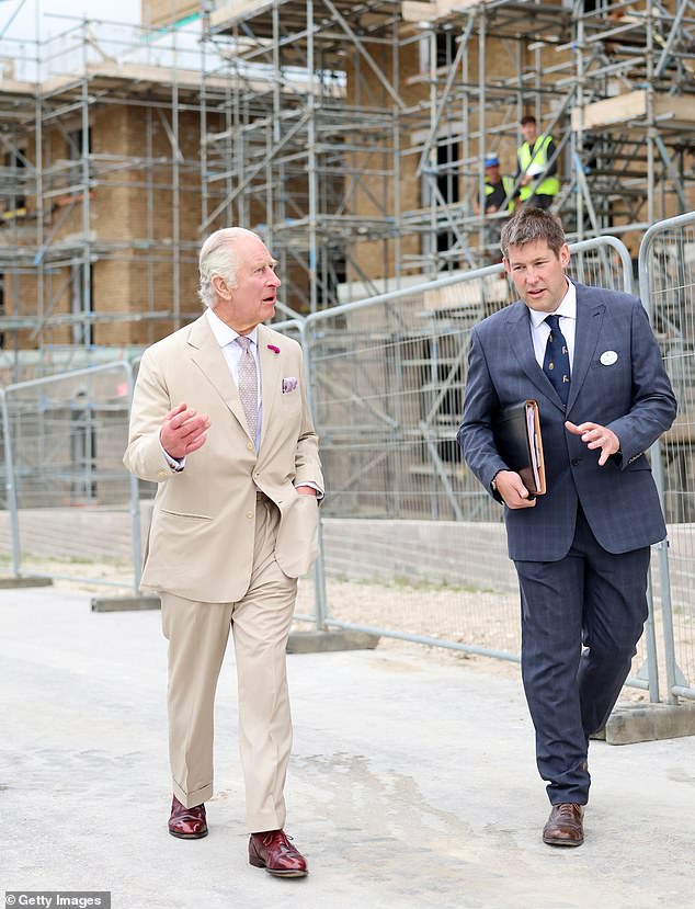 King Charles visiting a Poundbury construction site with Peter Lacey the project manager