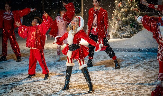 Kylie Minogue is thrashing her rivals Wham! In her bid to win the coveted Christmasnumber one spot (pictured in the music video for her song XMAS)
