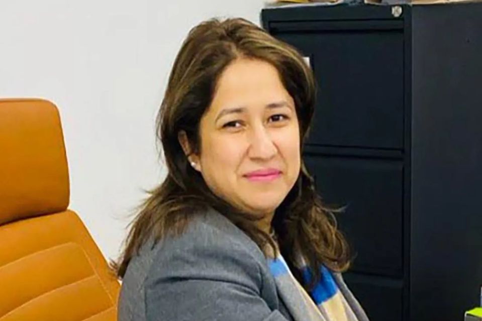 An image collage containing 1 images, Image 1 shows Woman with dark hair, wearing a gray blazer and striped scarf, sitting in an orange office chair