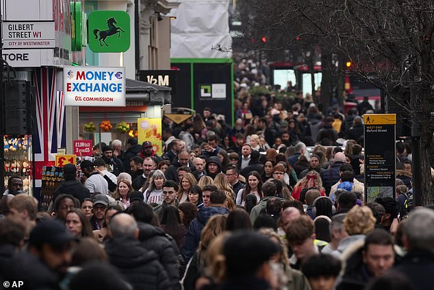 Shoppers walk along London's most famous shopping Street, Oxford Street, on Monday