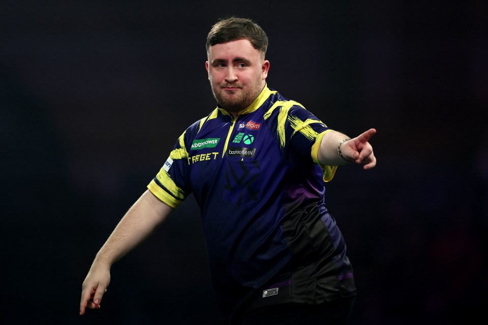 Luke Littler of England celebrates a win during the World Darts Championship.