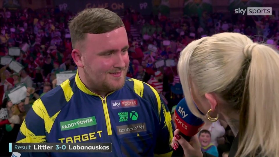 Professional darts player Littler smiles while being interviewed by a Sky Sports reporter after defeating Labanauskas 3-0.