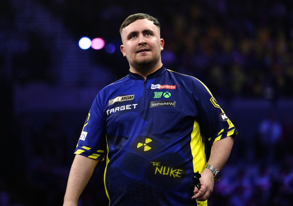 Luke Littler in his darts uniform.