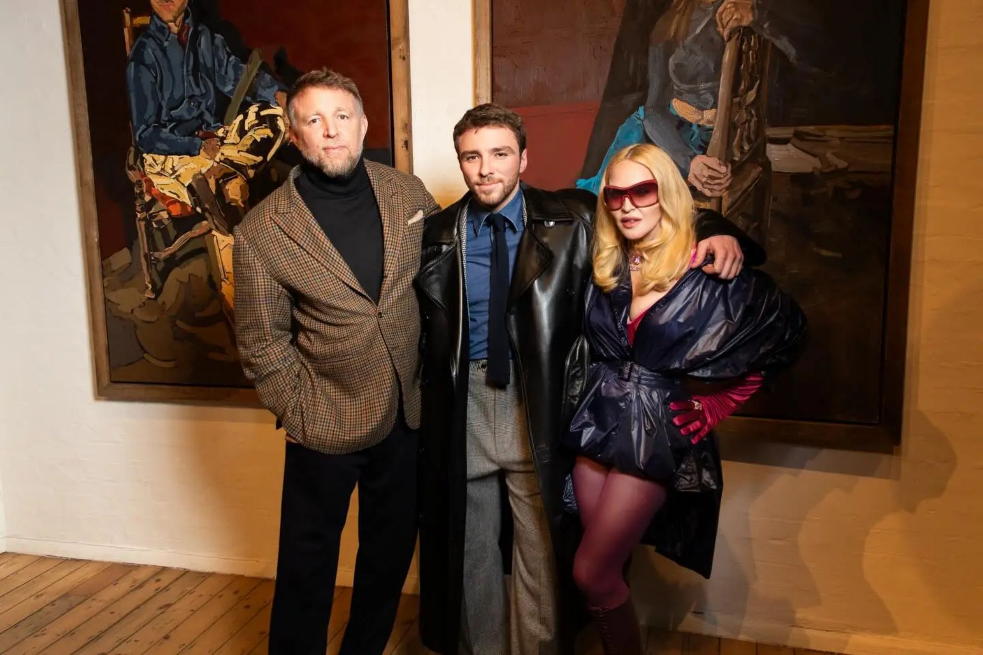 An image collage containing 1 images, Image 1 shows Madonna, Rocco Ritchie, and Guy Ritchie pose at Rocco Ritchie's art exhibition opening night