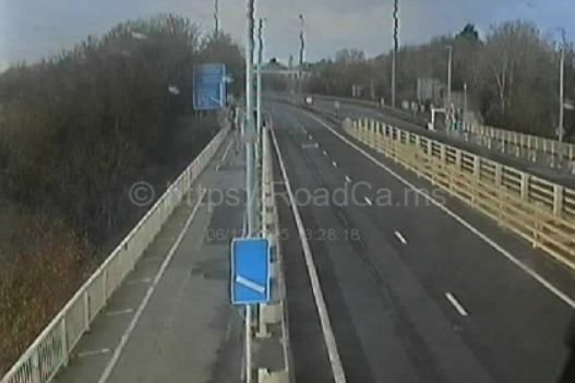 Overhead view of a highway with traffic flowing away from the camera.