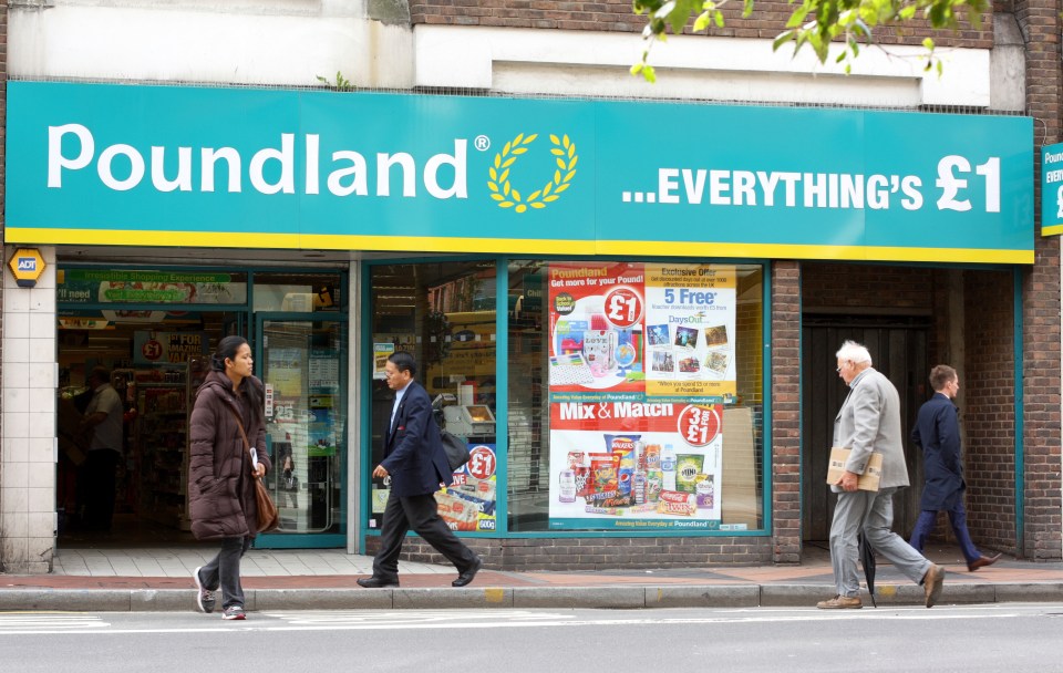 Pedestrians walk past a Poundland store in Reading, England.