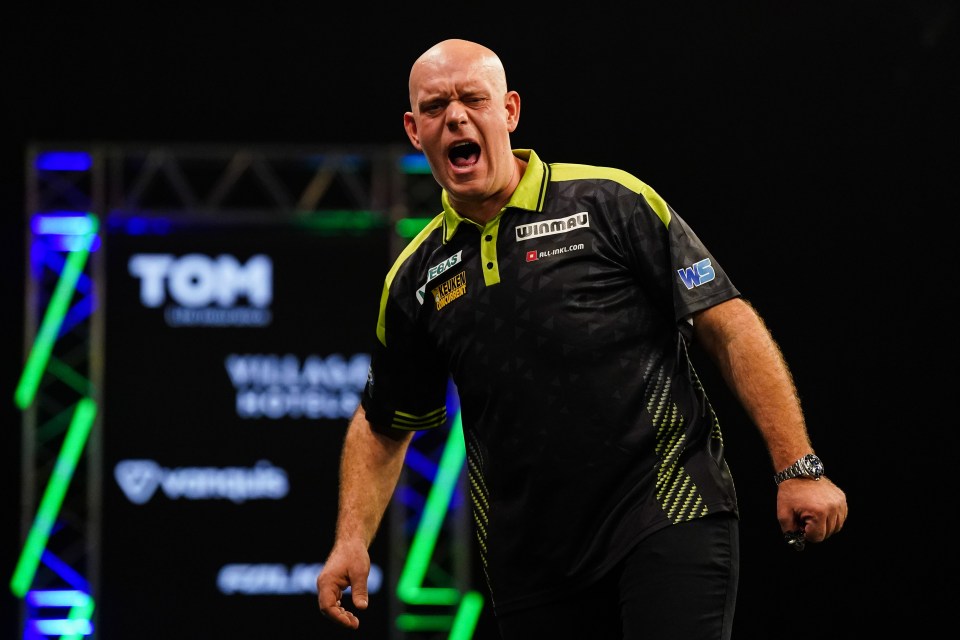 Michael van Gerwen reacts during his darts match.