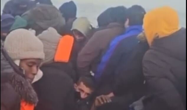 Orange Nike trainers are passed around the boat by the migrants to get water out of the bottom