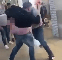 Moment two thugs brawl in busy shopping centre in front of little girl whose family stand and watch