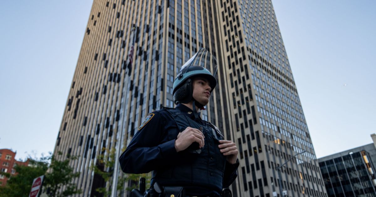 An NYPD Strategic Response Group officer stands guard outside of 26 Federal Plaza on Oct. 21, 2025, in New York City.