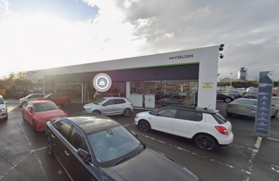 A car dealership with several cars parked outside.