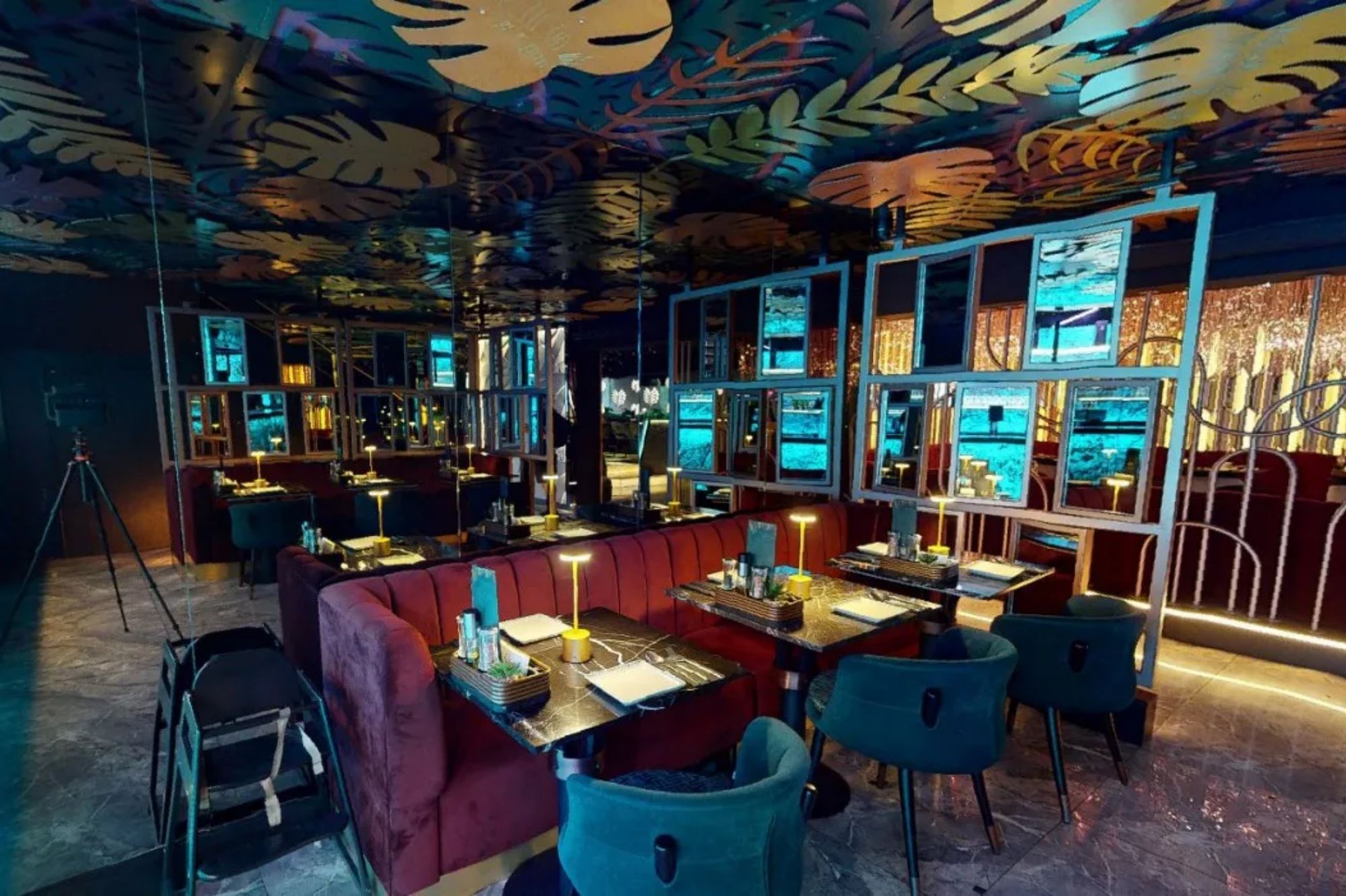 An image collage containing 1 images, Image 1 shows Interior of a restaurant with velvet banquettes, gold leaf ceiling, and teal lighting