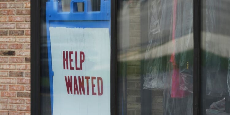 "Help Wanted" sign is displayed at a dry cleaner in Rolling Meadows, Illinois, on May 15, 2025.