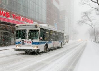 A bus drives through the winter on Broadway near 68th street in New York City during a snowfall on Feb. 9, 2017.