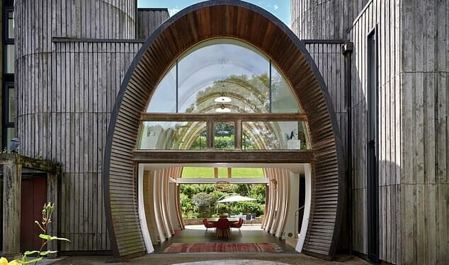 Th spectacular full height circular stone entrance greets visitors to the house