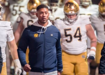 Head Coach Marcus Freeman of the Notre Dame Fighting Irish leads his team into the stadium Nov. 29 to start the second half of a college football game against the Stanford Cardinals in Palo Alto, California.