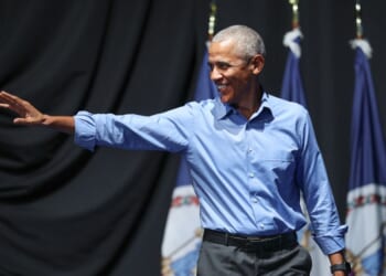 Former President Barack Obama waves to the crowd as he attends a campaign rally with Virginia Democratic gubernatorial candidate, former Rep. Abigail Spanberger, in the Chartway Arena on Nov. 1, 2025, in Norfolk, Virginia.