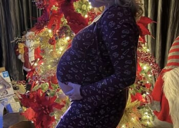 Pregnant Perrie Edwards, 32, cradled her baby bump as she posed for gorgeous Christmas snaps in front of her tree