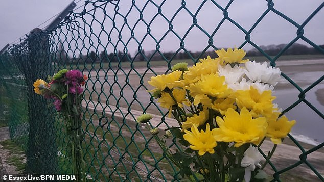 Flowers pictured at the scene. Police rushed to the body of water just after 2pm on Sunday