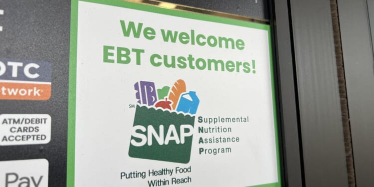 Sign at supermarket entrance with text reading We Welcome EBT customers and a SNAP logo in Lafayette, California, on Nov. 13, 2025.