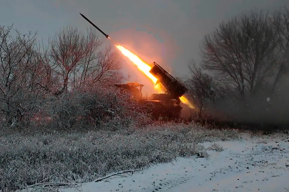 Missile launch from a military vehicle in a snowy field.