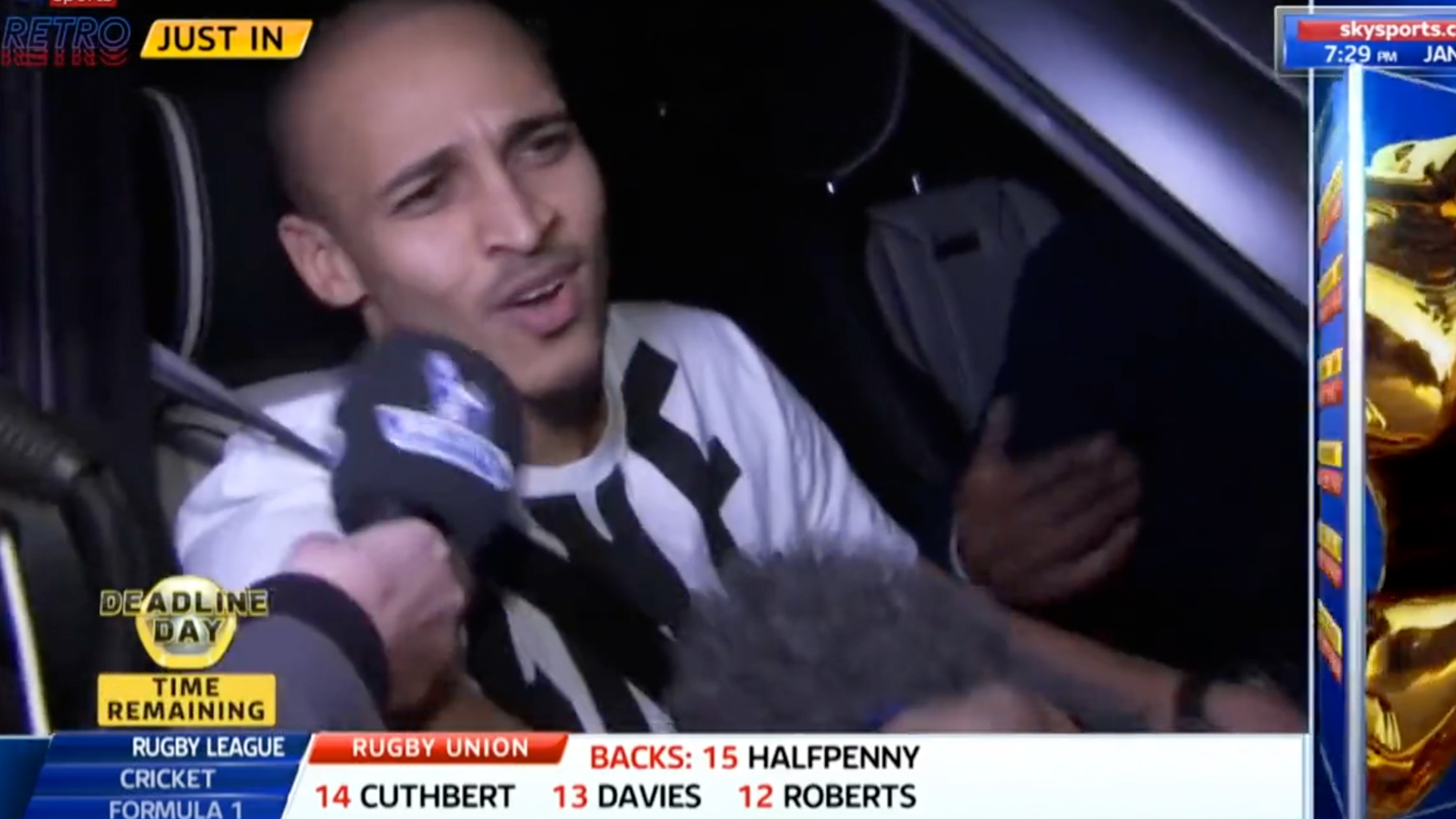 A man in a car speaks into a microphone, with "JUST IN" and "DEADLINE DAY" visible on screen.