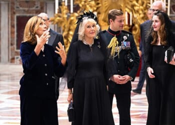 Major Ollie Plunket, pictured standing behind Queen Camilla, has served as Her Majesty's first-ever equerry since 2022