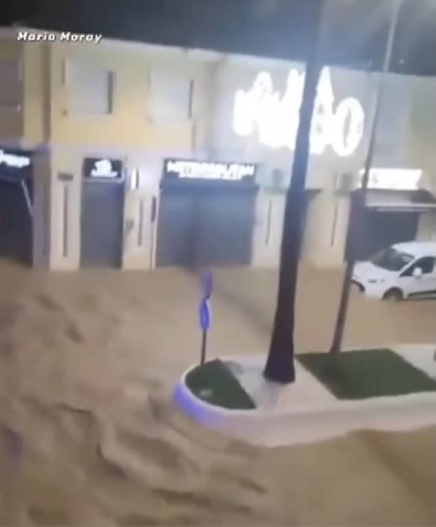 Vehicles can also be seen bobbing through the murky waters as the strong currents swirl around them, leaving tourists and locals trapped in their building