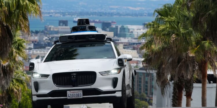 A Waymo car drives up a hill in San Francisco on Sept. 4, 2025.