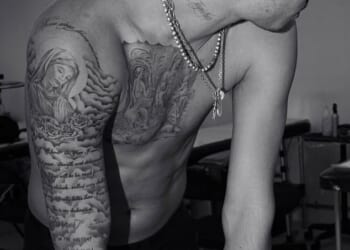 Romeo Beckham has shared a new photo showing off his extensive tattoo collection as he appears to steer clear of ongoing family drama involving his brother Brooklyn